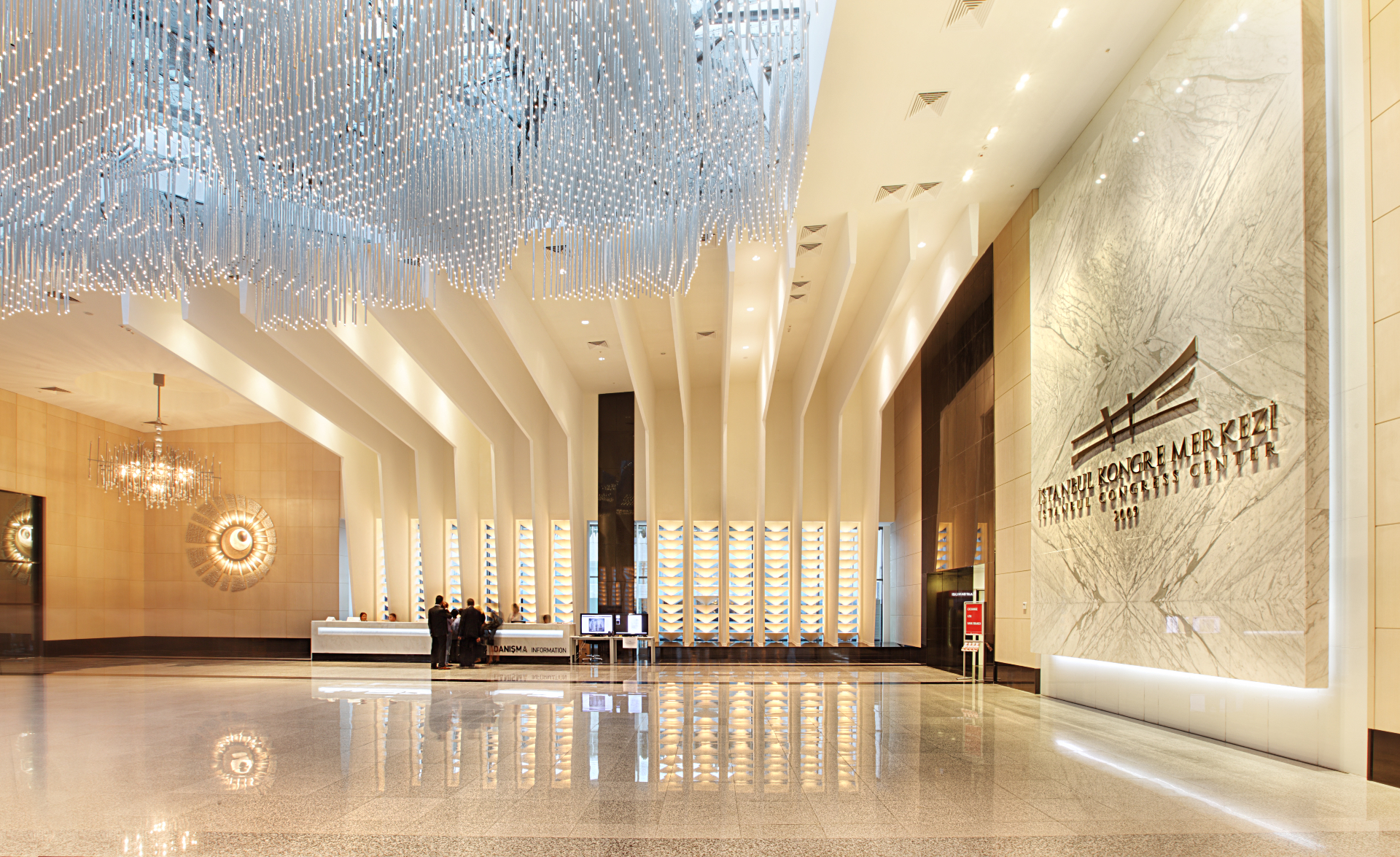 Grand luxury lobby with sculptural chandelier and marble surfaces